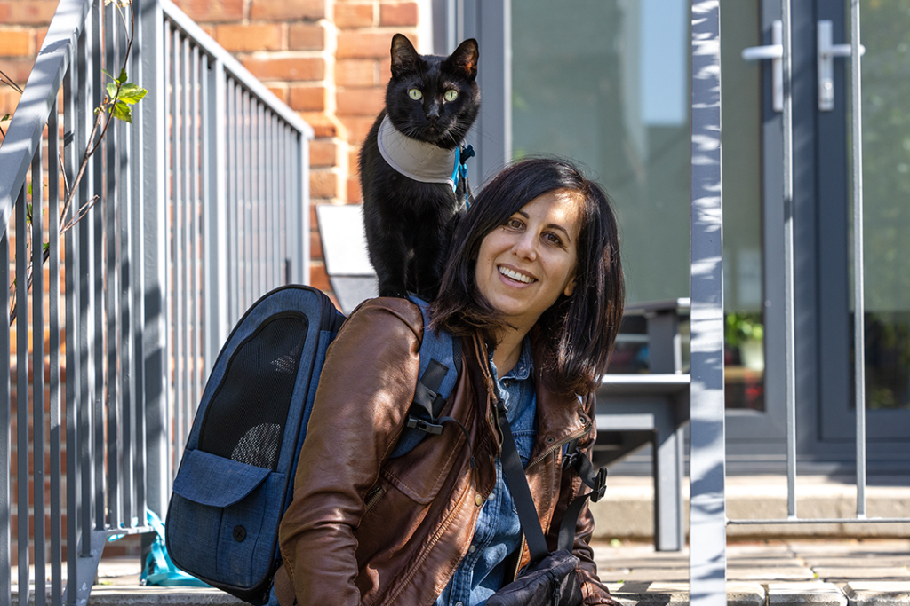 Julie & Jones - woman with black cat riding on her shoulders