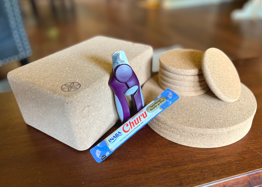 tools for cat nail trims - clippers, yoga block, cork coasters and trivets, churu cat treat